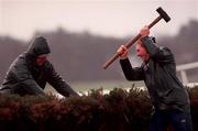 31 December 2000; Race stewards attempt to mend the Hurdle in windy conditions during day three of the Christmas Festival at Leopardstown Racecourse in Dublin. Photo by Aoife Rice/Sportsfile