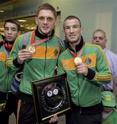9 June 2013; Ireland's Jason Quigley, left, and John Joe Nevin, who won gold medals in the 75Kg Middleweight and 56kg Bantamweight divisions respectively, on their arrival home from the EUBC European Men's Boxing Championships 2013 in Belarus, at Dublin Airport. Photo by Matt Browne/Sportsfile