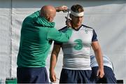 2 October 2015; Ireland's Chris Henry is strapped up by team doctor Dr. Eanna Falvey before squad training. Ireland Rugby Squad Training, 2015 Rugby World Cup, Surrey Sports Park, University of Surrey, Guildford, England. Picture credit: Brendan Moran / SPORTSFILE