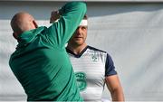 2 October 2015; Ireland's Chris Henry is strapped up by team doctor Dr. Eanna Falvey before squad training. Ireland Rugby Squad Training, 2015 Rugby World Cup, Surrey Sports Park, University of Surrey, Guildford, England. Picture credit: Brendan Moran / SPORTSFILE