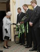 7 May 2009; Her Majesty the Queen is shown the RBS Six Nations trophy by Tom Court and the Triple Crown trophy by Stephen Ferris, in the company of Jamie Heaslip, at a civic reception for Ireland Rugby Squad on the second day of her visit to Northern Ireland. Hillsborough Castle, Hillsborough, Co. Down. Picture credit: SPORTSFILE/ Niall Carson / PA POOL *** Local Caption ***