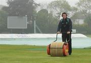 14 May 2009; Ireland captain Kyle McCallan attempts to clear water from the pitch after rain delayed play against Leicestershire. Friends Provident Trophy, Ireland v Leicestershire, Castle Avenue, Clontarf, Dublin. Picture credit: Pat Murphy / SPORTSFILE