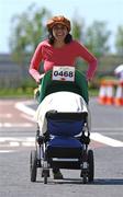 24 May 2009; Anisa Fortuin and her 15 month old son, Mika, from Adamstown, Lucan, Co. Dublin, in action during the Adamstown 8k Road Race. Adamstown, Lucan, Co. Dublin. Picture credit: Tomas Greally / SPORTSFILE