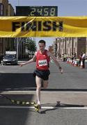 24 May 2009; Vinnie Mulvey, Raheny Shamrocks A.C, crosses the line to win the Adamstown 8k Road Race. Adamstown, Lucan, Co. Dublin. Picture credit: Tomas Greally / SPORTSFILE