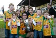 11 October 2015; Michael Farragher of Corofin poses for a photograph with the cup and a group of young supporters following the Galway County Senior Football Championship Final match between Mountbellew/Moylough and Corofin at Tuam Stadium in Tuam, Galway. Photo by Sam Barnes/Sportsfile