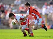 31 May 2009; Declan Connolly, Tyrone, in action against Gavin McParland, Armagh. Ulster GAA Football Minor Championship, Tyrone v Armagh, St. Tiernach's Park, Clones, Co.Monaghan. Photo by Sportsfile