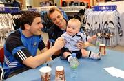 30 May 2009; Dublin fans turned out at Arnotts to cheer on their team as they prepare for the 2009 Championship season. Captain Paul Griffin, right, and Bernard Brogan with Matthew Jago Loughnane, age 9 months, from Ballyfermot, while signing autographs in the sports department of Arnotts. Arnott's, Henry St, Dublin. Picture credit: Brendan Moran / SPORTSFILE