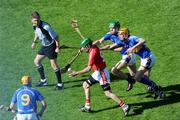 31 May 2009; Jerry O'Connor, Cork, is tackled by Tipperary players Noel McGrath and Seamus Callanan under the watchful eyes of Shane McGrath, left, and referee Barry Kelly. Munster GAA Hurling Senior Championship Quarter-Final, Tipperary v Cork, Semple Stadium, Thurles, Co. Tipperary. Picture credit: Ray McManus / SPORTSFILE