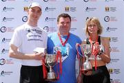 1 June 2009; The Men's and Women's winners in the Bord Gais Energy Cork City Marathon, Michael Herlihy, from Charleville, Co Cork, who finished in a time of 2:30.36 and 50 year old Lucy Brennan, from Sligo, who finished in a time of 2:51.25 with John Mullins, Chief Executive, Bord Gais Energy. Close to to 10,000 runners took part in the biggest ever Marathon that Cork has seen. St Patrick's Street, Cork. Picture credit: Brendan Moran / SPORTSFILE