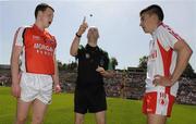 31 May 2009; Armagh captain Declan McKenna and Tyrone captain Sean Warnock watch as referee Fergal Cleary makes the toss before the game. Ulster GAA Football Minor Championship, Tyrone v Armagh, St. Tiernach's Park, Clones, Co. Monaghan. Picture credit: Oliver McVeigh / SPORTSFILE