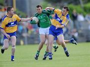 7 June 2009; Jason Stokes, Limerick, is tackled by Conor Whelan, 3, and Kevin Dilleen, 6, Clare. Munster GAA Football Senior Championship Semi-Final, Clare v Limerick, Cusack Park, Ennis, Co. Clare. Picture credit: Matt Browne / SPORTSFILE