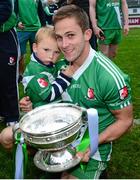18 October 2015; Sarsfields Conor Tiernan and his son Harry, aged 2, celebrate with the Dermot Bourke cup after the game. Kildare County Senior Football Championship Final, Athy v Sarsfields. St Conleth's Park, Newbridge, Co. Kildare. Picture credit: Piaras Ó Mídheach / SPORTSFILE