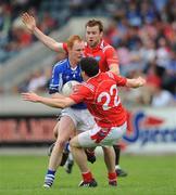 14 June 2009; Padraig Clancy, Laois, in action against Adrian Reid, 22, and Mick Fanning, Louth. GAA Football Leinster Senior Championship Quarter-Final, Laois v Louth, Parnell Park, Dublin. Picture credit: Ray McManus / SPORTSFILE *** Local Caption ***