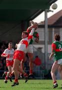 5 April 1998; Liam McHale of Mayo goes up for a high ball against Anthony Tohill of Derry, as Anthony Tohill of Mayo, 8, looks on during the Church & General National Football League quarter-final match between Derry and Mayo at Pairc Markievicz in Sligo. Photo by David Maher/Sportsfile