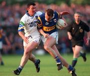 30 May 1998; Brian Burke of Tipperary is tackled by George Walsh of Waterford during the Munster Senior Football Championship Second Round match between Tipperary and Waterford at Ned Hall Park in Clonmel. Photo by Ray McManus/Sportsfile