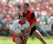 17 May 1998; Ciaran Loughran of Tyrone in action against Simon Poland of Down during the Ulster GAA Football Senior Championship Preliminary Round match between Tyrone and Down at St Tiernach's Park in Clones, Monaghan. Photo by David Maher/Sportsfile