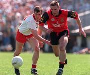 17 May 1998; Fay Devlin of Tyrone in action against Barry Burns of Down during the Ulster GAA Football Senior Championship Preliminary Round match between Tyrone and Down at St. Tiernach's Park in Clones, Co Monaghan. Photo by David Maher/SPORTSFILE