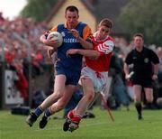 31 May 1998 Keith Byrne (Wicklow) is tackled by  David Brennan (Louth) during the Louth v Wicklow Bank of Ireland   Football Championship Drogheda Co.Louth Picture Credit Matt Browne SPORTSFILE
