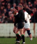 Linesman PJ Quinn takes the dog off the field at half-time during the Down v Kildare National League game in Newry. 14/12/97. Photograph David Maher SPORTSFILE.