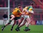 12 April 1998; Ronan Mooney of Offaly in action against Brian Roper of Donegal during the Church & General National Football League Semi-Final match between Donegal and Offaly at Croke Park in Dublin. Photo by Ray McManus/Sportsfile