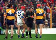 19 July 1998; Brian Lohan, right, of Clare and Michael White of Waterford are booked by referee Willie Barrett before being sent off during the Munster GAA Hurling Senior Championship Final Replay match between Clare and Waterford at Semple Stadium in Thurles, Co Tipperary. Photo by Ray McManus/Sportsfile