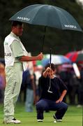 28 July 1996; Alison Nicholas of England lines up a putt as she is shielded from the rain by her caddie on the 4th green during the final round of the Guardian Ladies Irish Open at Citywest Golf Club in Dublin. Photo by David Maher/Sportsfile