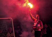 6 January 2001; A Cork City fan holds a flare prior to the  FAI Harp Lager Cup Second Round match between Longford Town and Cork City at Flancare Park in Longford. Photo by David Maher/Sportsfile