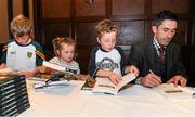 22 October 2015; Rory Kavanagh, right, signs books with the help from his nephews Kevin Gray, age 11, left, Conall Gray, age 6, and niece Aoife Gray, age 4, at the launch of 'Winning' by Rory Kavanagh. Mount Errigal Hotel, Ballyraine, Letterkenny, Co. Donegal. Picture credit: Seb Daly / SPORTSFILE