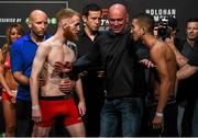 23 October 2015; Paddy Holohan, left, faces off against Louis Smolka ahead of their flyweight bout. UFC Fight Night Weigh In. 3Arena, Dublin. Picture credit: Ramsey Cardy / SPORTSFILE