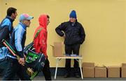 25 October 2015; Programme seller Sean O'Halloran looks on as Na Piarsaigh players make their way to their dressing room ahead of the game. AIB Munster GAA Senior Club Hurling Championship, Sixmilebridge v Na Piarsaigh. O'Garney Park, Sixmilebridge, Co. Clare. Picture credit: Piaras Ó Mídheach / SPORTSFILE