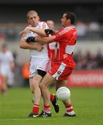 21 June 2009; Kevin Hughes, Tyrone, in action against Chrissy McKaigue, Derry. GAA Football Ulster Senior Championship Semi-Final, Tyrone v Derry, Casement Park, Belfast, Co. Antrim. Photo by Sportsfile