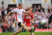21 June 2009; Kevin Hughes, Tyrone, in action against Gavin McShane, Derry. GAA Football Ulster Senior Championship Semi-Final, Tyrone v Derry, Casement Park, Belfast, Co. Antrim. Photo by Sportsfile
