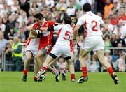 21 June 2009; Chrissy McKaigue, Derry, in action against Philip Jordan and Davy Harte, Tyrone. GAA Football Ulster Senior Championship Semi-Final, Tyrone v Derry, Casement Park, Belfast, Co. Antrim. Picture credit: Oliver McVeigh / SPORTSFILE