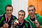 21 June 2009; Ireland's three goal medalists, Darren O'Neill, David Oliver Joyce and Con Sheehan, display the Gold Medals they won at the European Union Championships in Odense, Denmark, during the Irish team's arrival home at Dublin Airport, Dublin. Picture credit: John Barrington / SPORTSFILE