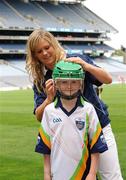 23 June 2009; Cork Ladies footballer Angela Walsh helps 8 year old Sean Kinsella put on his helmet at the launch of the Vhi GAA Cúl Camp Ambassador Programme. Fifty GAA senior county players will be visiting 927 camps this summer. Book your child’s place at www.vhiculcamps.gaa.ie. Croke Park, Dublin. Photo by Sportsfile *** Local Caption ***