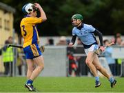 25 October 2015; Will O'Donoghue, Na Piarsaigh, celebrates after the game as Aidan Quilligan, Sixmilebridge, looks on dejected. AIB Munster GAA Senior Club Hurling Championship, Sixmilebridge v Na Piarsaigh. O'Garney Park, Sixmilebridge, Co. Clare. Picture credit: Piaras Ó Mídheach / SPORTSFILE