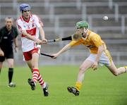 28 June 2009; Mickey McGlade, Derry, in action against Christopher McGuinness, Anrtrim . ESB Ulster Minor Hurling Championship Final, Anrtrim v Derry, Casement Park, Belfast, Co. Antrim. Picture credit: Oliver McVeigh / SPORTSFILE