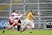 28 June 2009; Matthew Donnelly, Anrtrim, in action against  Gavin O'Neill and Mickey McGlade, Derry. ESB Ulster Minor Hurling Championship Final, Anrtrim v Derry, Casement Park, Belfast, Co. Antrim. Picture credit: Oliver McVeigh / SPORTSFILE