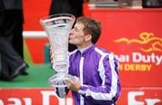 28 June 2009; Johnny Murtagh celebrates with the trophy after winning the Dubai Duty Free Irish Derby on Fame And Glory. Irish Derby Festival - Sunday, Curragh Racecourse, Co. Kildare. Picture credit: Matt Browne / SPORTSFILE