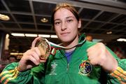 28 June 2009; Katie Taylor celebrates with her gold medal upon her arrival at Dublin Airport after she was crowned European Union champion for the second year running following an 8-1 win over Bulgarian lightweight Denitza Eliseevan in Pazardjik, Bulgaria yesterday. Dublin Airport, Dublin. Photo by Sportsfile