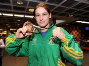 28 June 2009; Katie Taylor celebrates with her gold medal upon her arrival at Dublin Airport after she was crowned European Union champion for the second year running following an 8-1 win over Bulgarian lightweight Denitza Eliseevan in Pazardjik, Bulgaria yesterday. Dublin Airport, Dublin. Photo by Sportsfile