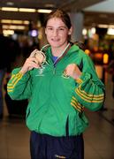 28 June 2009; Katie Taylor celebrates with her gold medal upon her arrival at Dublin Airport after she was crowned European Union champion for the second year running following an 8-1 win over Bulgarian lightweight Denitza Eliseevan in Pazardjik, Bulgaria yesterday. Dublin Airport, Dublin. Photo by Sportsfile