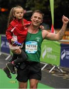 26 October 2015; John Flynn and his daughter Eva, aged seven, on their way to finishing the SSE Airtricity Dublin Marathon 2015, Merrion Square, Dublin. Picture credit: Tomas Greally / SPORTSFILE