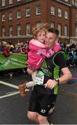 26 October 2015; Ruairi McLaughlin carries his daughter Anna, from Co. Donegal, to the finish during the SSE Airtricity Dublin Marathon 2015, Merrion Square, Dublin.Picture credit: Ray McManus / SPORTSFILE