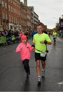 26 October 2015; Barry Doyle, from Co. Galway, and his daughter Mia on their way to finishing the SSE Airtricity Dublin Marathon 2015, Merrion Square, Dublin.Picture credit: Ray McManus / SPORTSFILE