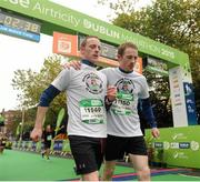 26 October 2015; Ciaran, left, and Conor Maloney, congratulate each other after crossing the finish line at the the SSE Airtricity Dublin Marathon 2015, Merrion Square, Dublin. Picture credit: Seb Daly / SPORTSFILE