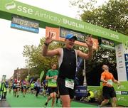 26 October 2015; Dermot Hickey celebrates after crossing the finish line at the SSE Airtricity Dublin Marathon 2015, Merrion Square, Dublin. Picture credit: Seb Daly / SPORTSFILE