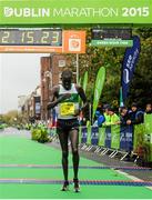 26 October 2015; Freddy Sittuk, Raheny Shamrock AC, Dublin, crosses the finish line at the SSE Airtricity Dublin Marathon 2015, Merrion Square, Dublin. Picture credit: Tomas Greally / SPORTSFILE