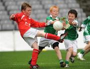 1 July 2009; Rory Hanlon, St. Nicholas, Co. Louth, has his shot blocked by Ross Bolger and Eoin Fitzpatrick, right, Killeshan, Co. Laois, during the Leinster GAA Go Games ‘Play & Stay with the GAA’ activity day. Croke Park, Dublin. Picture credit: Pat Murphy / SPORTSFILE