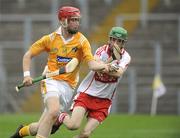 28 June 2009; Conor McCann, Anrtrim, in action against Ciaran Conway, Derry. ESB Ulster Minor Hurling Championship Final, Anrtrim v Derry, Casement Park, Belfast, Co. Antrim. Picture credit: Oliver McVeigh / SPORTSFILE